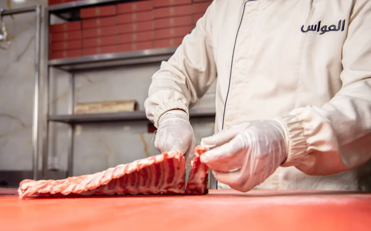 Al Awas butcher preparing fresh marinated cuts